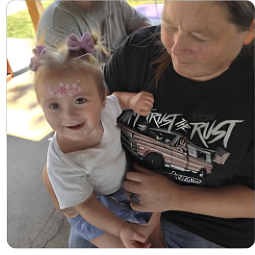 Toddler with a pink crown face paint design