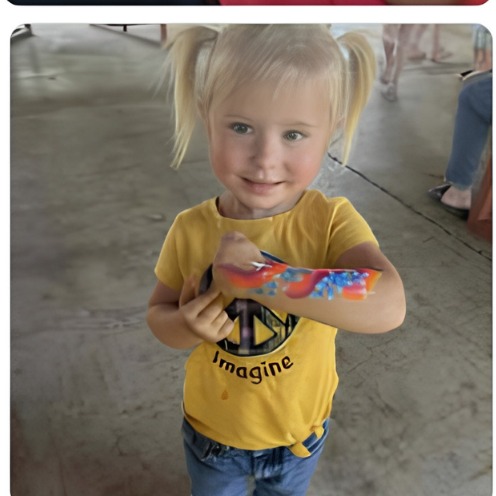 Toddler with a colorful rainbow arm design