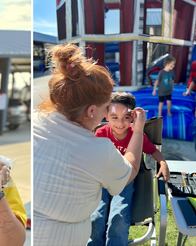Sabrina painting a child's face at a fair