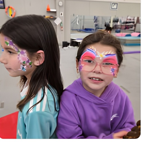 Two girls with colorful face paint designs