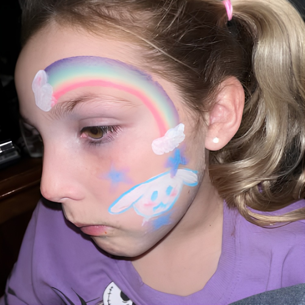 Pastel rainbow and bunny cheek face paint design
