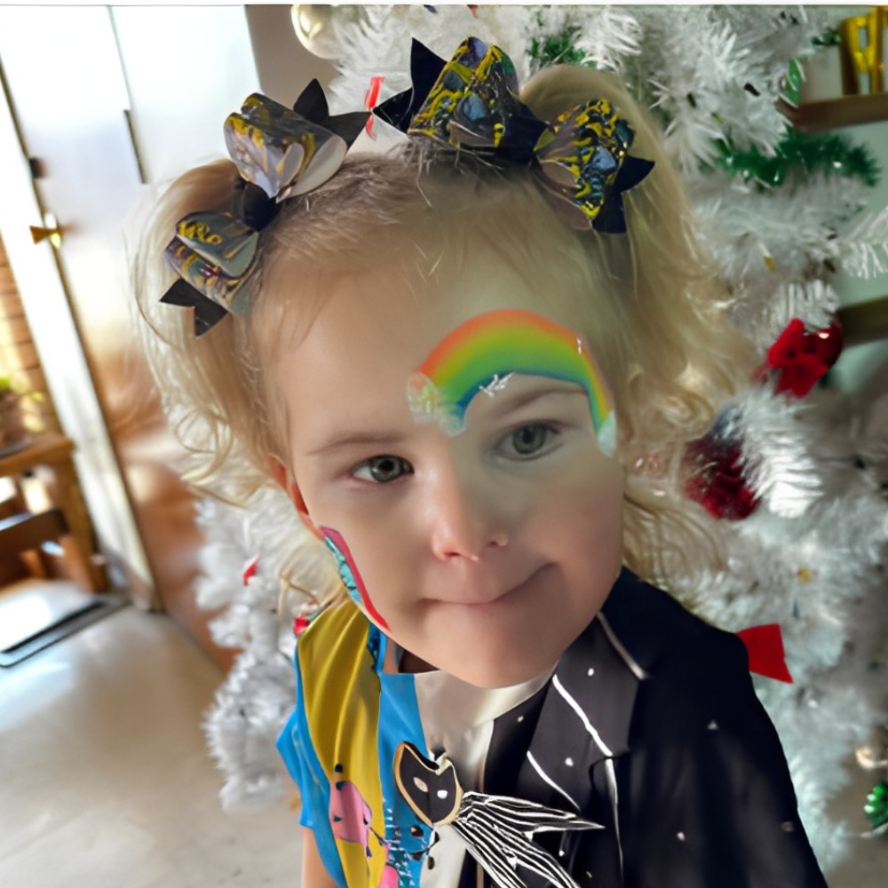 Rainbow arch face paint design on a toddler